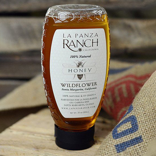 Honey packaging featuring a honeycomb-textured squeeze bottle with clean branding and wildflower honey label