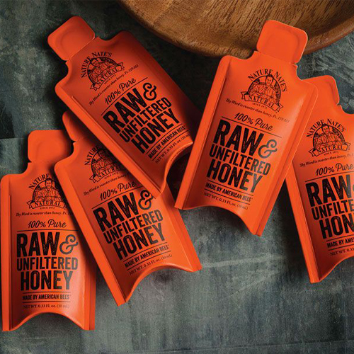 Honey packaging featuring flexible stand-up pouches designed for convenient storage and shelf visibility