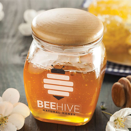 Transparent honey jar with bee style brand logo